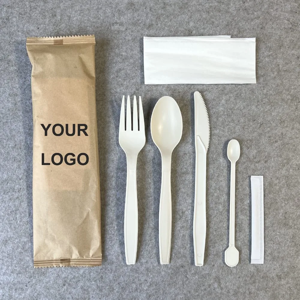 Biodegradable cutlery set with fork, spoon, knife, stirrer, and napkin in custom paper bag packaging used by U.S. takeout brand GreenBite.