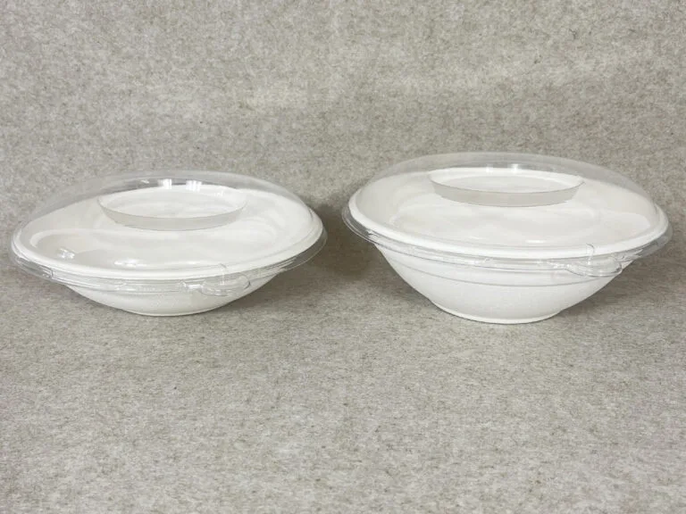 A vibrant poke bowl served in a compostable bagasse hexagonal bowl with a clear lid, showcasing sustainable packaging for modern foodservice.