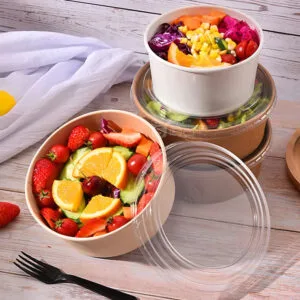 Fresh fruit salads served in kraft paper salad bowls with clear lids, showcasing vibrant ingredients and eco-friendly packaging design.