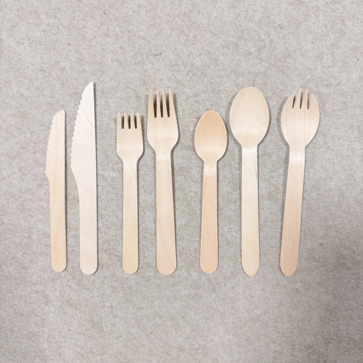 Disposable wooden cutlery including wooden forks, spoons and knives made from natural birch wood