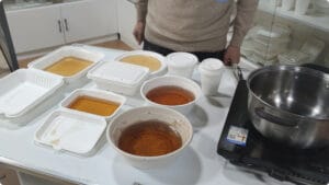 Bioleader® Bagasse Tableware testing for high-temperature, waterproof, and oil-resistant properties. Clamshell containers, bowls, and plates under test conditions.