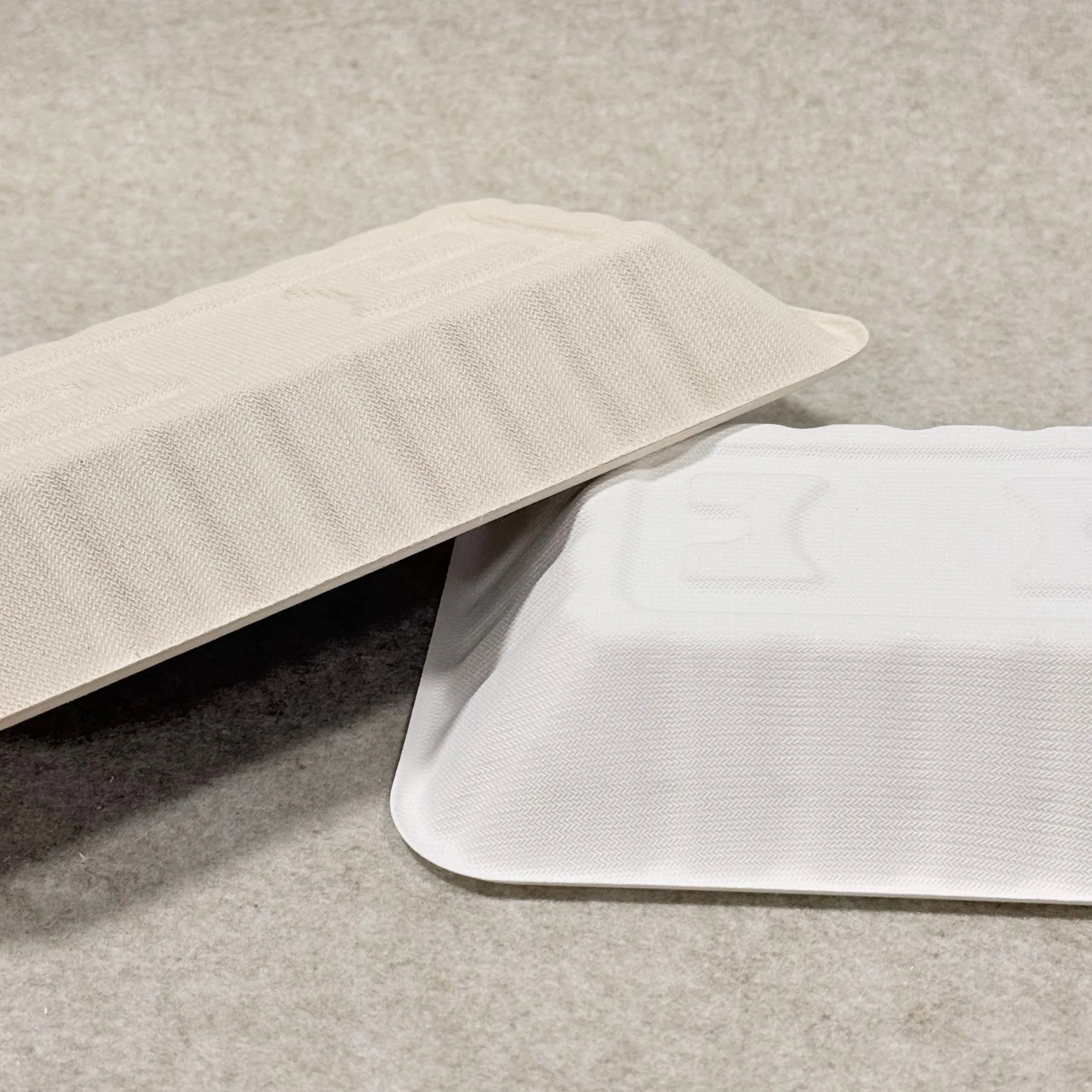 Back view of brown and white bagasse fruit trays